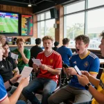 Pembuat taruhan antusias yang terlibat dalam taruhan mix parley di sportsbook yang penuh semangat.