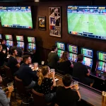 Engaged fans placing bets at okking during live sports events, immersed in the competitive atmosphere.